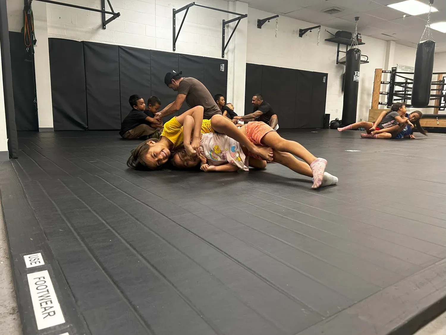 808 Top Team students drilling ground positions on the mats at Iron Kingz