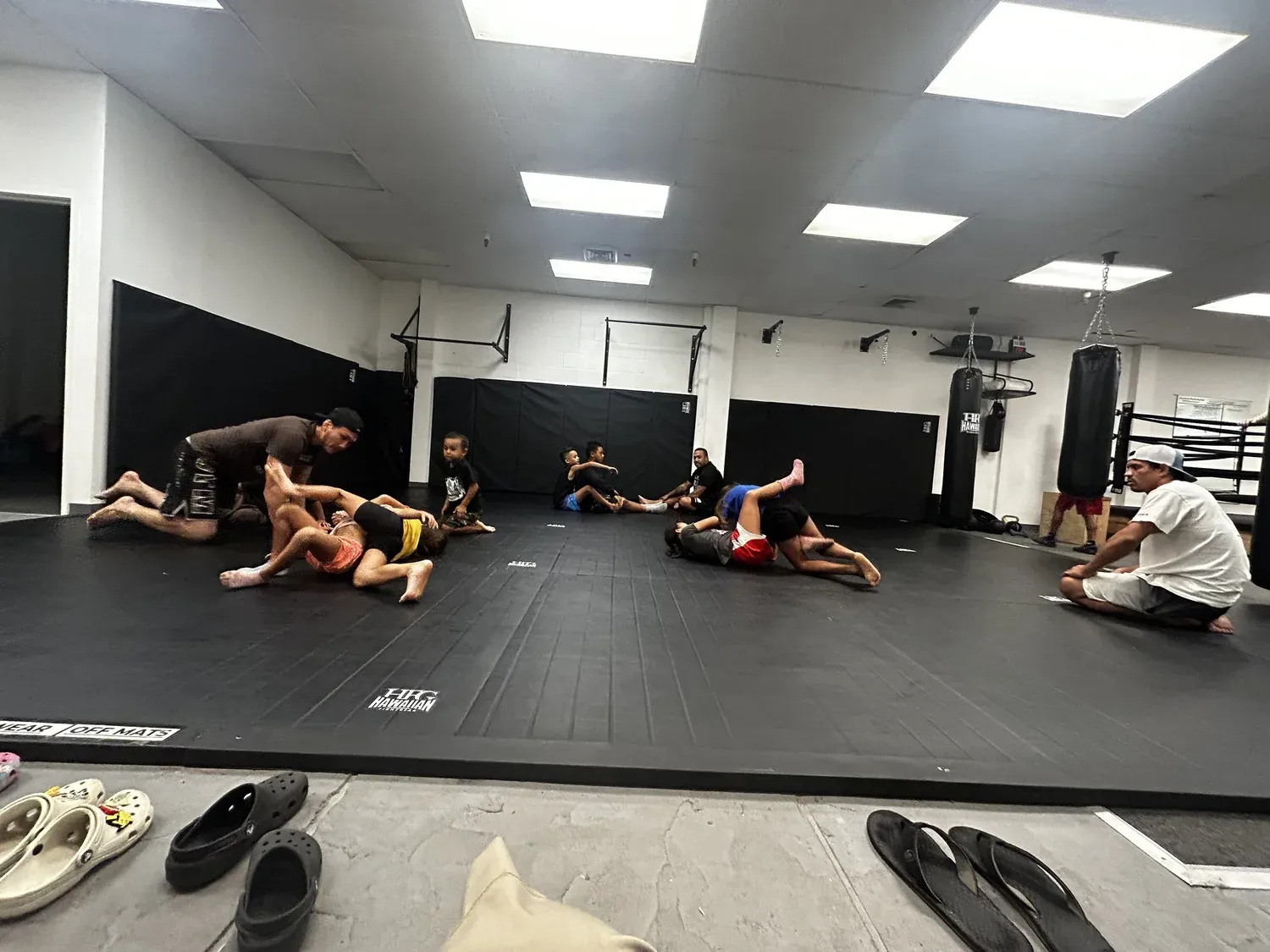 Brazilian Jiu-Jitsu open mat with students grappling at Iron Kingz