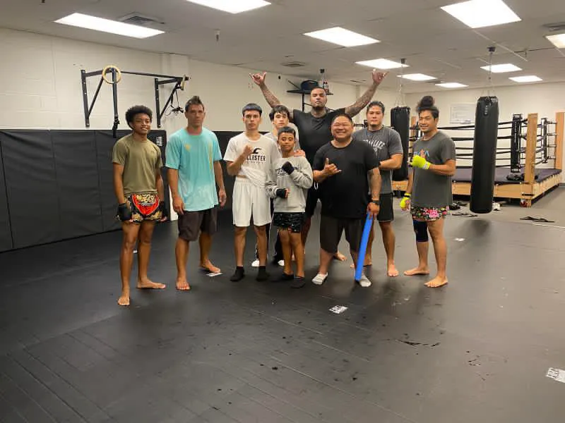 Iron Kingz members and coach gathered in the ring